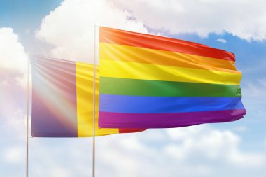 Sunny blue sky and flags of lgbt and romania