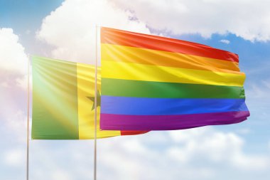 Sunny blue sky and flags of lgbt and senegal