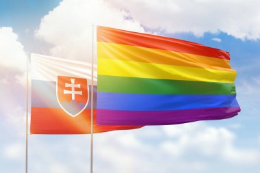 Sunny blue sky and flags of lgbt and slovakia