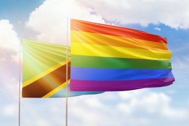 Sunny blue sky and flags of lgbt and tanzania