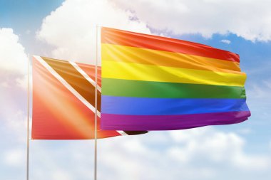 Sunny blue sky and flags of lgbt and trinidad and tobago