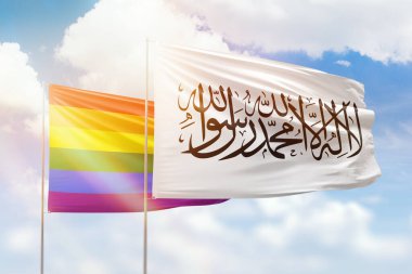 Sunny blue sky and flags of lgbt and afghanistan