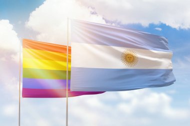 Sunny blue sky and flags of lgbt and argentina