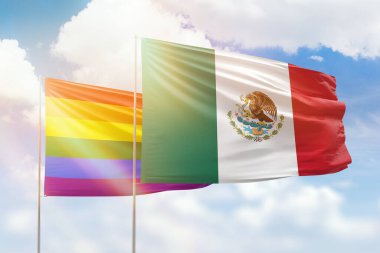 Sunny blue sky and flags of lgbt and mexico