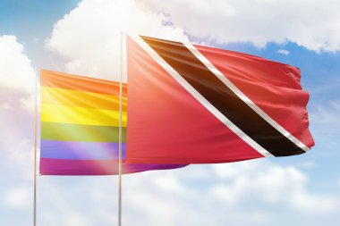 Sunny blue sky and flags of lgbt and trinidad and tobago