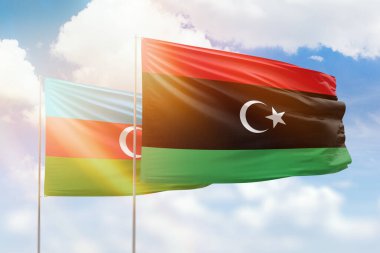 Sunny blue sky and flags of libya and azerbaijan