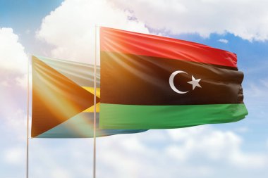 Sunny blue sky and flags of libya and bahamas