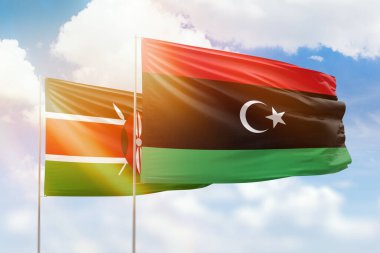 Sunny blue sky and flags of libya and kenya