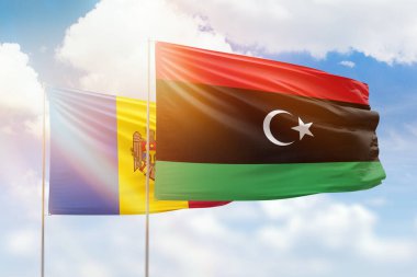 Sunny blue sky and flags of libya and moldova