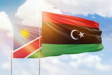 Sunny blue sky and flags of libya and namibia