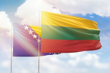 Sunny blue sky and flags of lithuania and bosnia