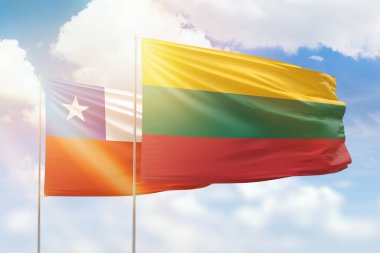 Sunny blue sky and flags of lithuania and chile