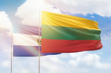 Sunny blue sky and flags of lithuania and el salvador