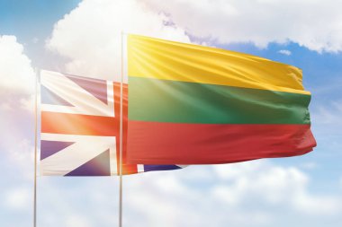 Sunny blue sky and flags of lithuania and great britain