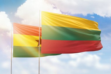Sunny blue sky and flags of lithuania and ghana