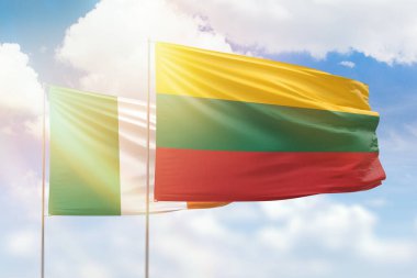 Sunny blue sky and flags of lithuania and ireland