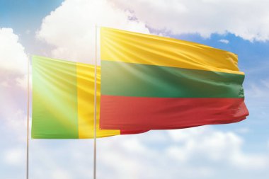 Sunny blue sky and flags of lithuania and mali