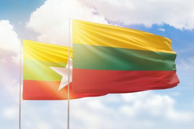 Sunny blue sky and flags of lithuania and myanmar