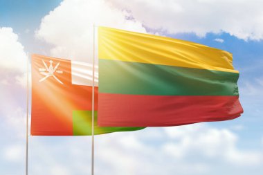 Sunny blue sky and flags of lithuania and oman