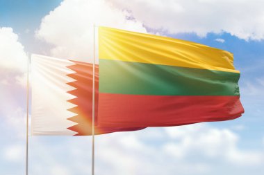 Sunny blue sky and flags of lithuania and qatar
