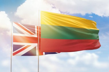 Sunny blue sky and flags of lithuania and united kingdom