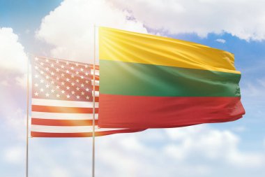 Sunny blue sky and flags of lithuania and usa