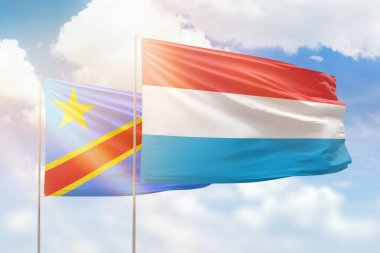 Sunny blue sky and flags of luxembourg and dr congo