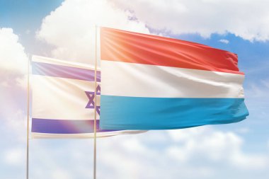 Sunny blue sky and flags of luxembourg and israel