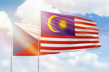 Sunny blue sky and flags of malaysia and czechia
