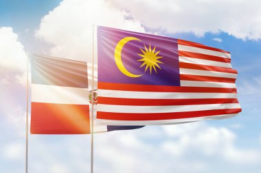 Sunny blue sky and flags of malaysia and dominican republic