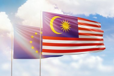 Sunny blue sky and flags of malaysia and european union