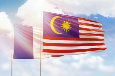 Sunny blue sky and flags of malaysia and france