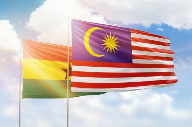 Sunny blue sky and flags of malaysia and ghana
