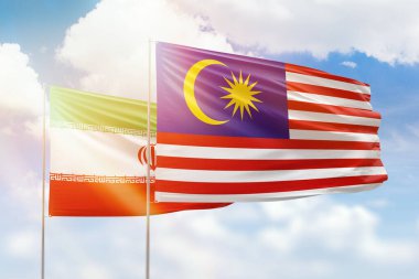 Sunny blue sky and flags of malaysia and iran