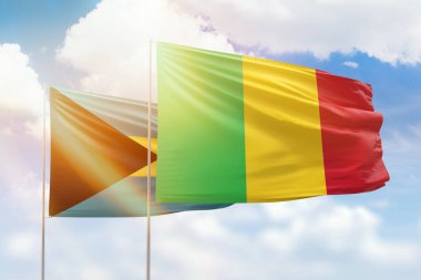 Sunny blue sky and flags of mali and bahamas