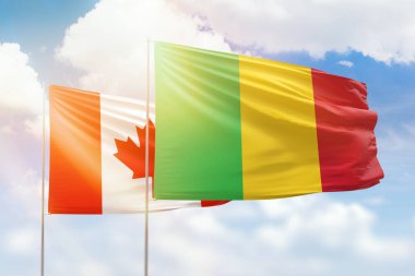 Sunny blue sky and flags of mali and canada