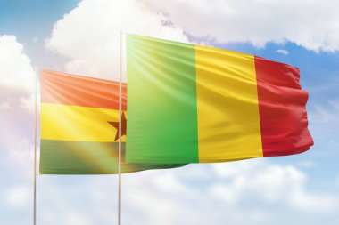 Sunny blue sky and flags of mali and ghana