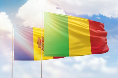 Sunny blue sky and flags of mali and moldova
