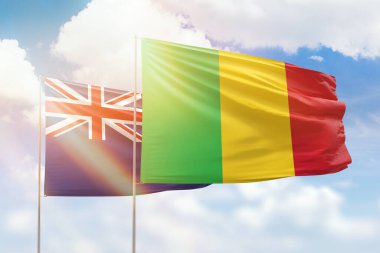 Sunny blue sky and flags of mali and new zealand