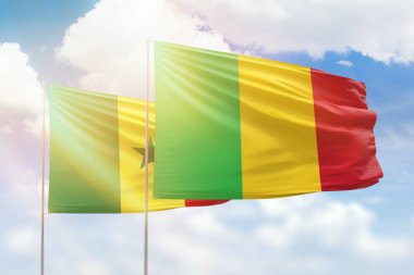 Sunny blue sky and flags of mali and senegal