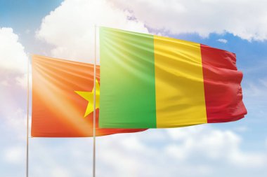 Sunny blue sky and flags of mali and vietnam
