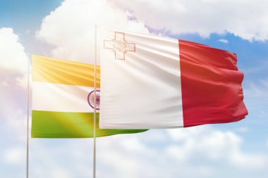 Sunny blue sky and flags of malta and india