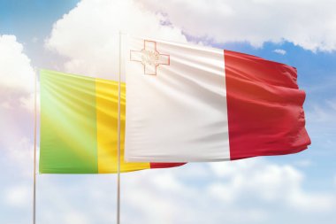 Sunny blue sky and flags of malta and mali