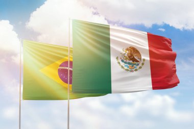 Sunny blue sky and flags of mexico and brazil
