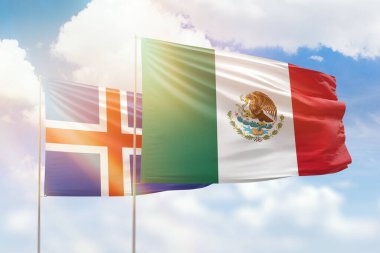 Sunny blue sky and flags of mexico and iceland