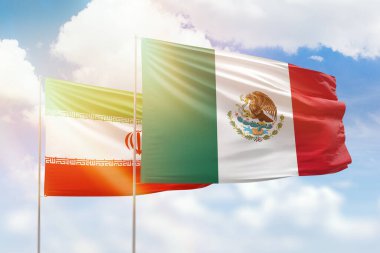 Sunny blue sky and flags of mexico and iran