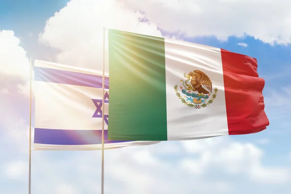 Sunny blue sky and flags of mexico and israel