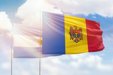 Sunny blue sky and flags of moldova and argentina