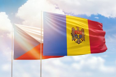 Sunny blue sky and flags of moldova and czechia