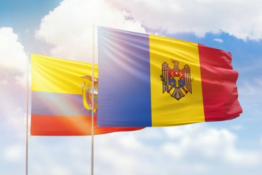 Sunny blue sky and flags of moldova and ecuador